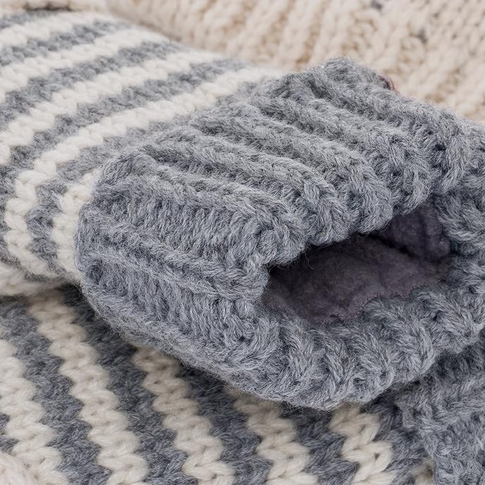 Fleece-lined inside of grey striped knit mitten showing soft inner fabric