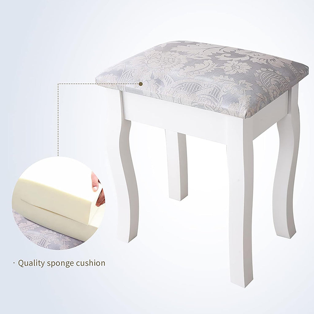 White cushioned vanity stool with patterned fabric top and curved apron legs
