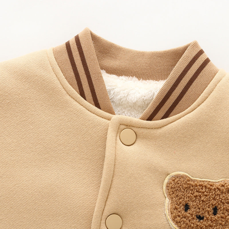 Fleece-lined baseball jacket close-up: striped rib collar and teddy bear chest patch.