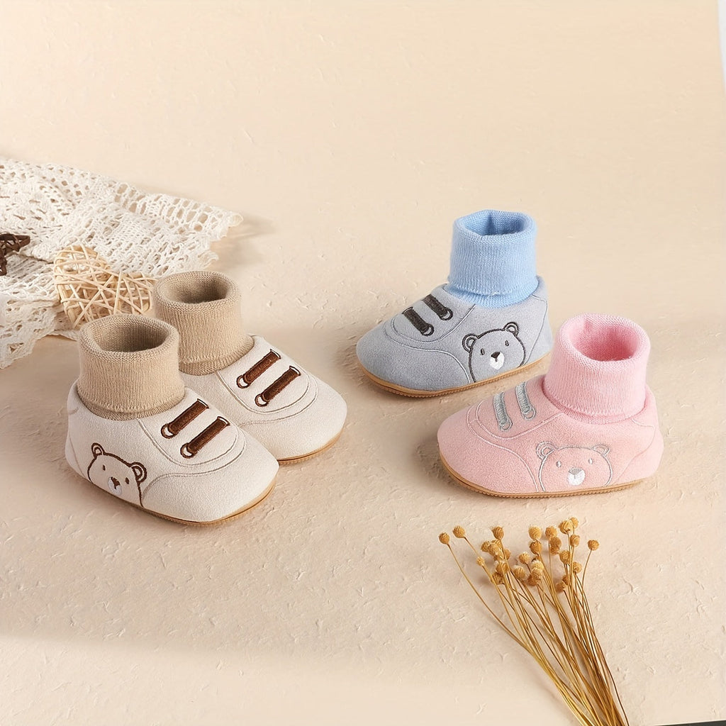Baby sock booties set in cream, blue, and pink with bear and cartoon design