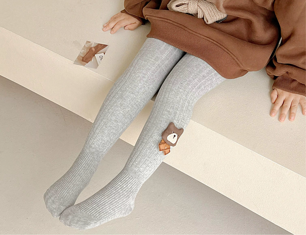 Gray fleece-lined ribbed footed leggings for toddlers, with small bear patch on ankle