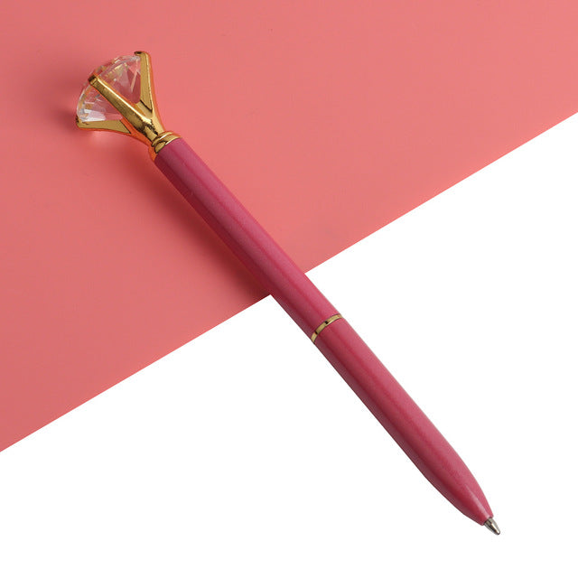 Pink gem-top metal ballpoint pen with faceted cap and smooth pink barrel