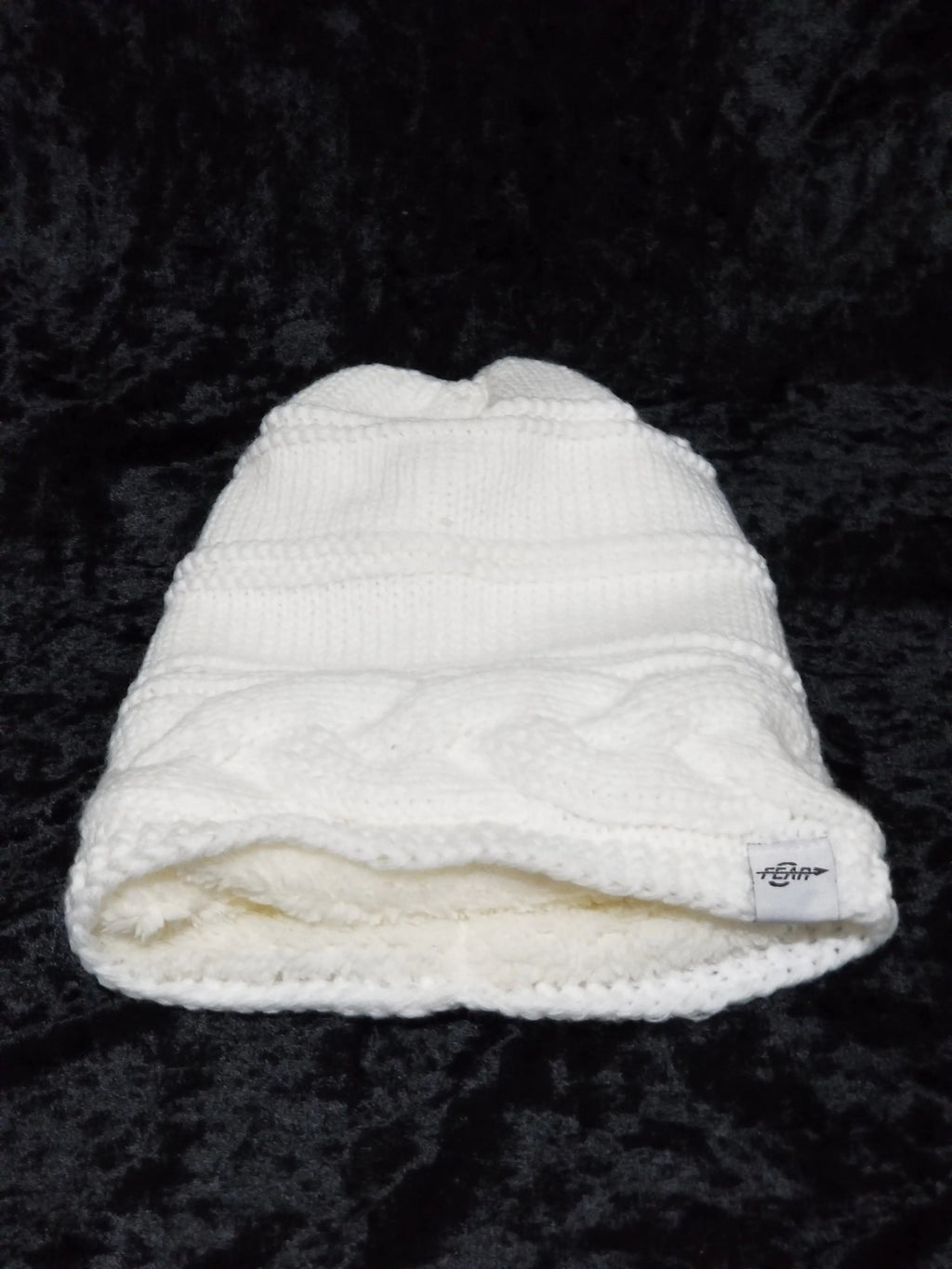 White ribbed knit beanie with cuff and small logo patch