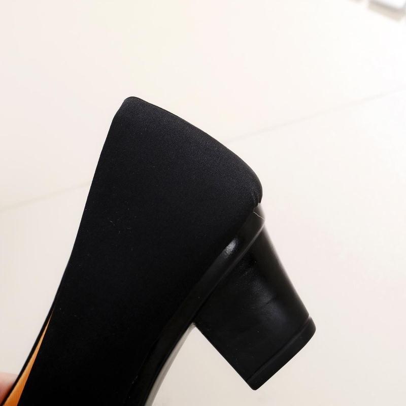 Women's black block-heel shoe close-up of fabric upper and chunky heel