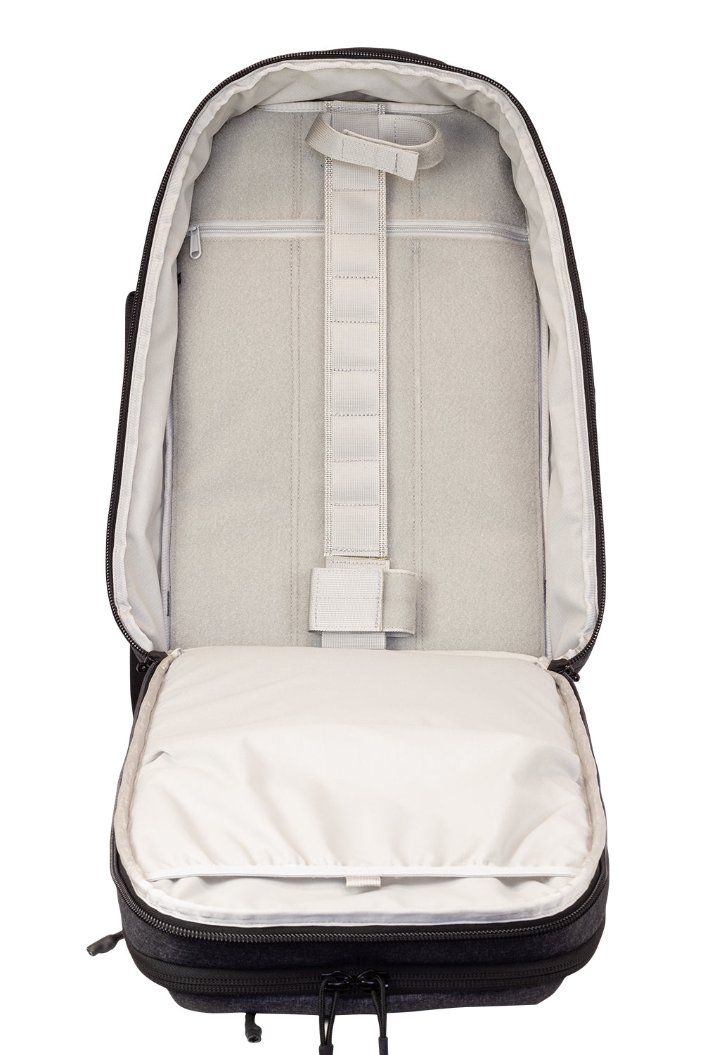 Open dark backpack showing light interior lining and storage compartments
