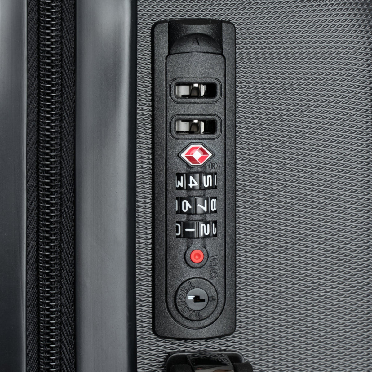 Hard-shell suitcase control panel, textured side with numeric lock keypad