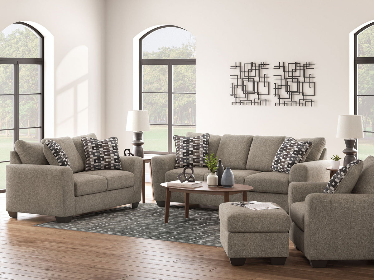 Beige fabric sofa with two seat cushions and black-and-white patterned throw pillows