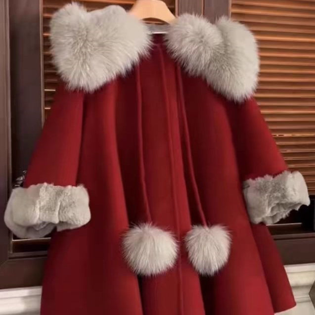 Red wool coat with plush fur collar, cuffs, and hem pom-poms