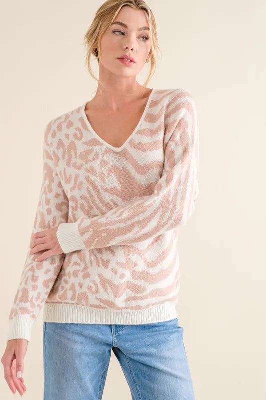 Pale pink V-neck sweater top with leopard and zebra pattern, long sleeves