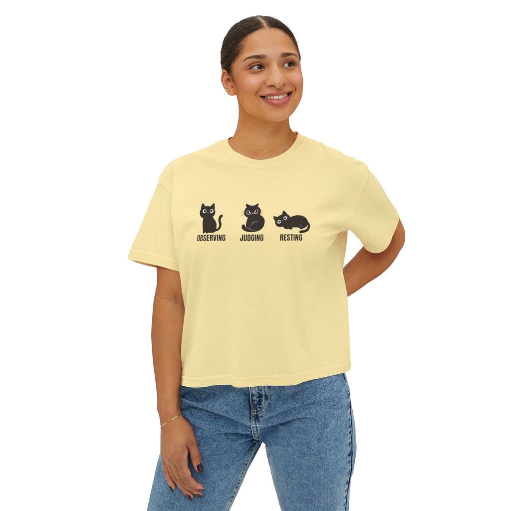 Butter yellow boxy cat tee with three cat faces graphic: observing, judging, resting
