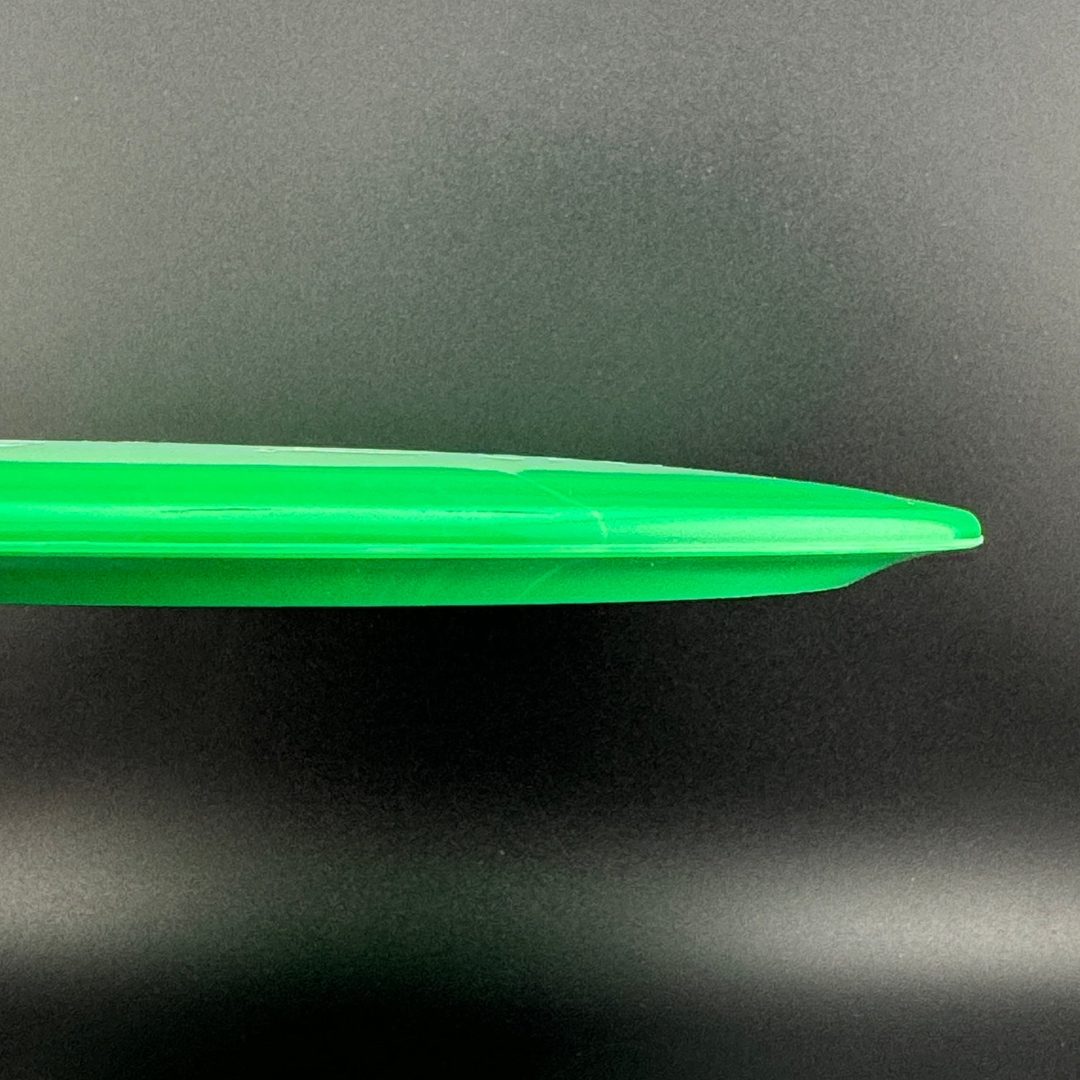 Green disc golf disc edge view with smooth outer rim