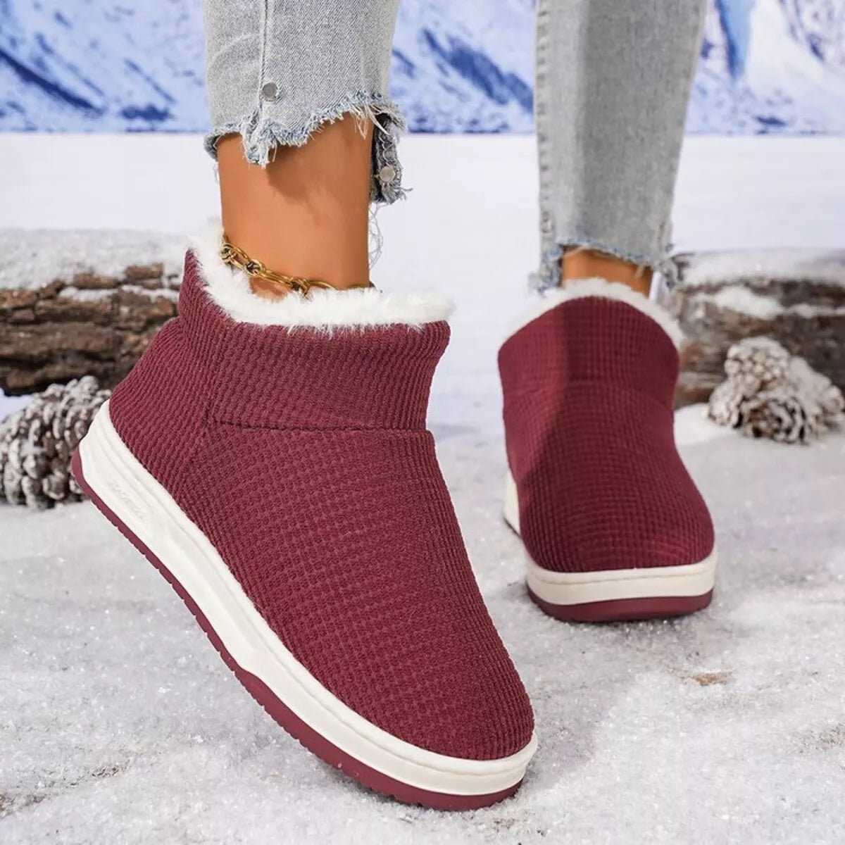 Burgundy knit ankle boots with plush white collar and cream rubber sole