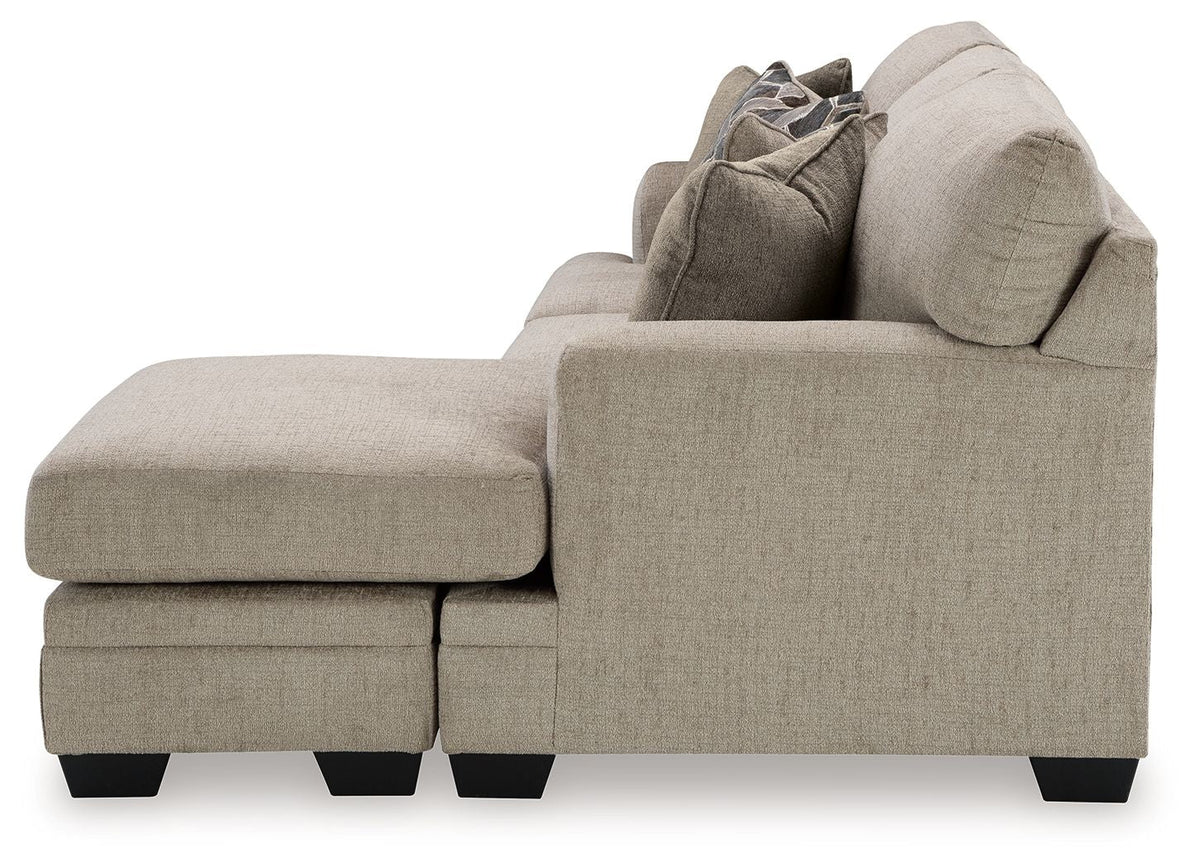 Upholstered loveseat with chaise-style profile, light gray-brown fabric and dark feet