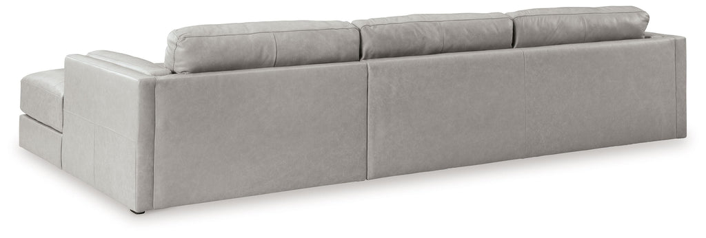 Light gray upholstered sectional sofa with chaise, clean-lined arms, and back cushions