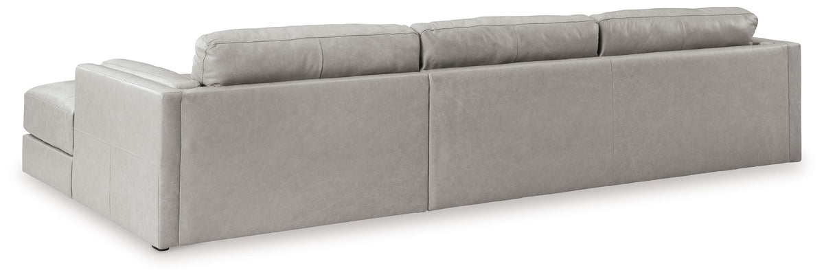 Light gray upholstered sectional sofa with chaise, clean-lined arms, and back cushions