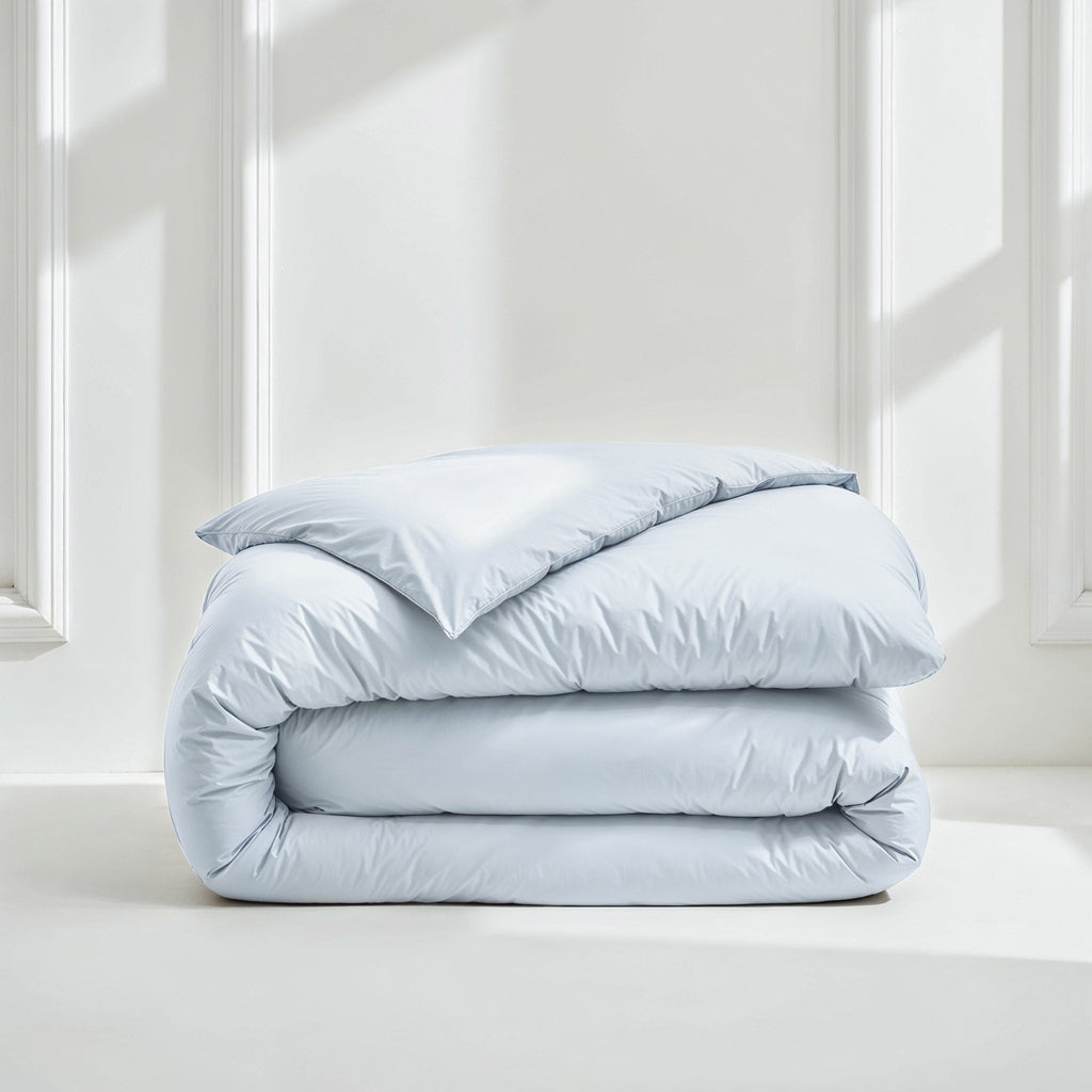 Light blue sateen duvet cover neatly folded with smooth, satiny surface
