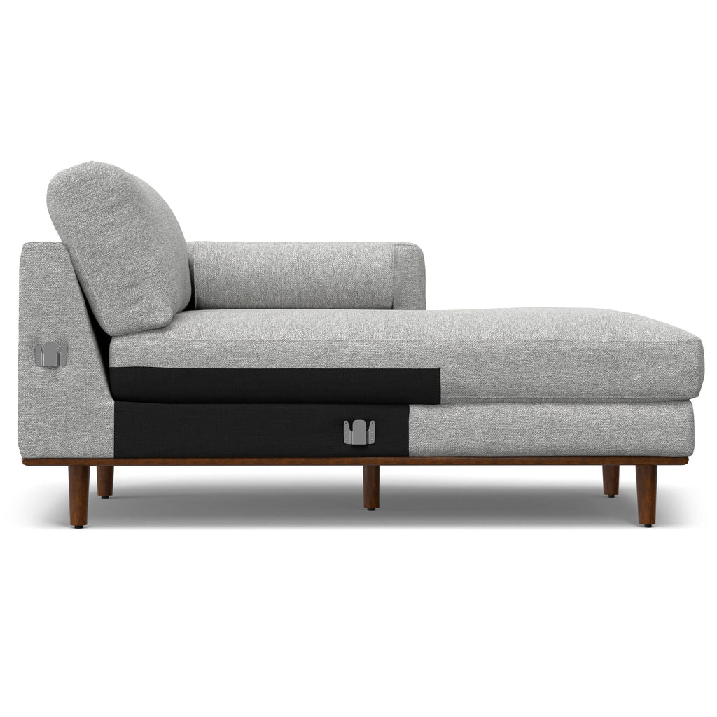 Upholstered sectional sofa in light gray fabric with rounded headrest pillow and chaise