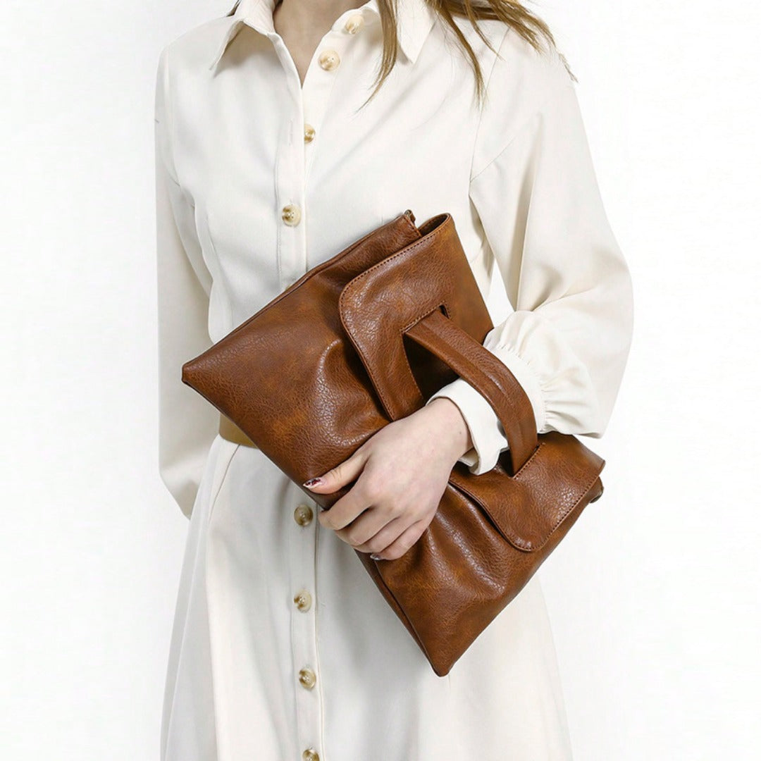 Brown leather envelope clutch purse with front flap and wrap-around shoulder strap