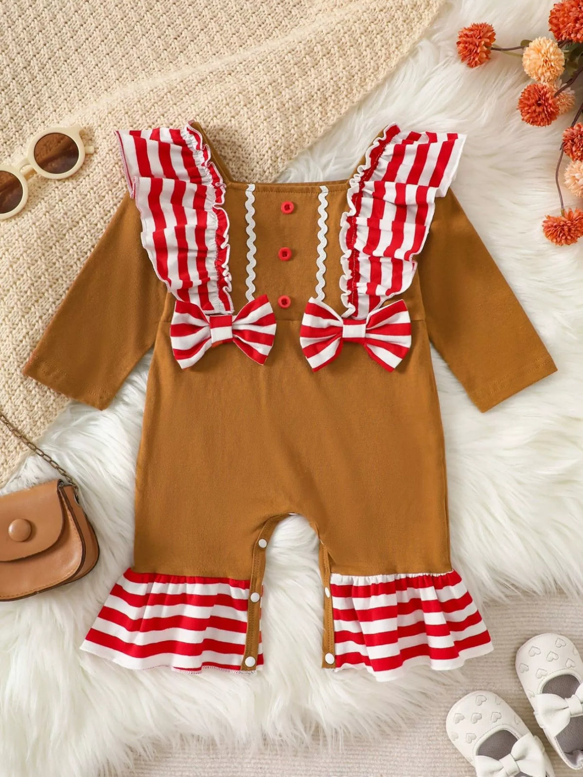 Caramel toddler gingerbread-style jumpsuit with red-and-white striped ruffle legs