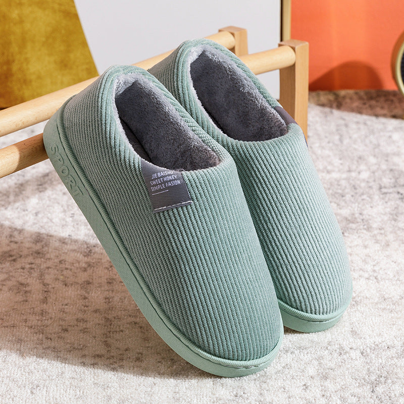 Green corduroy slip-on slippers with gray fuzzy lining and textured knit upper.