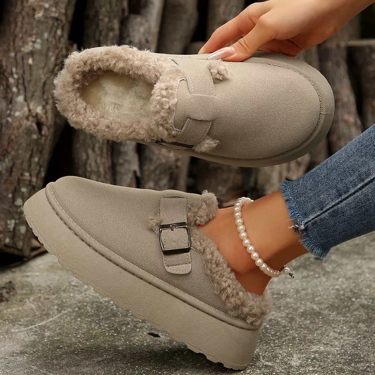 Beige platform slippers with fuzzy cuff, buckle strap, and thick sole