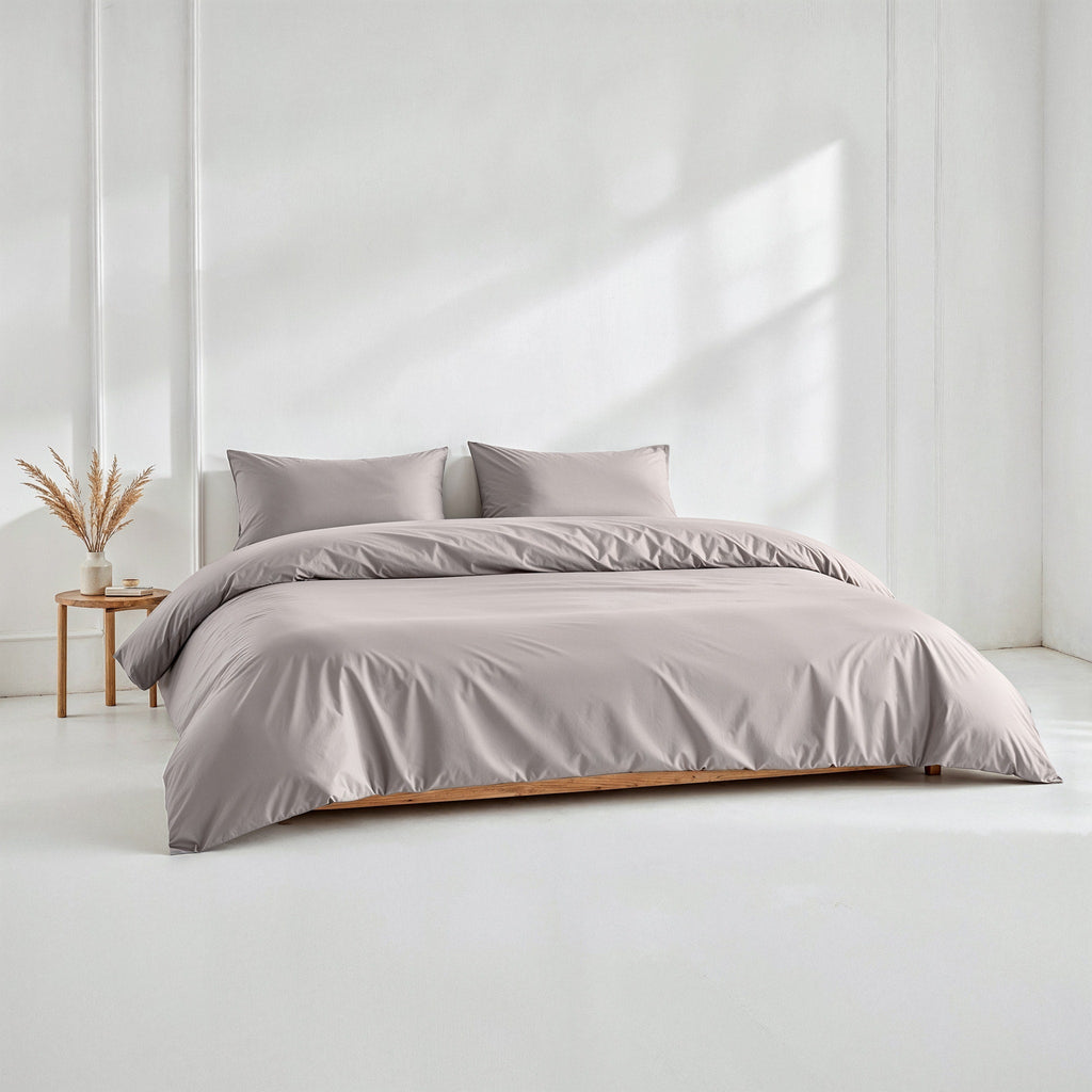 Light gray sateen duvet cover set with matching pillow shams on a bed