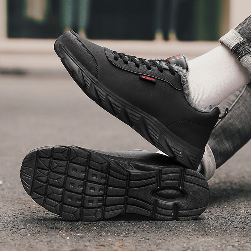 Men's black winter sneakers with plush collar and rugged outsole for grip.