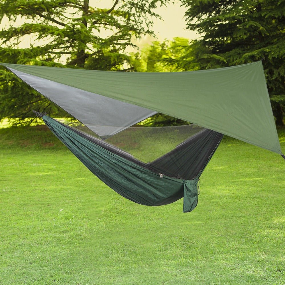 Green triangular waterproof canopy shade with hammock-style tent bed in outdoor setting