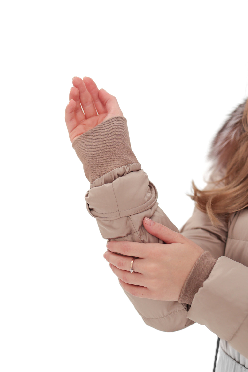 Beige snow suit sleeve and hand cuff detail with faux-fur cuff trim.