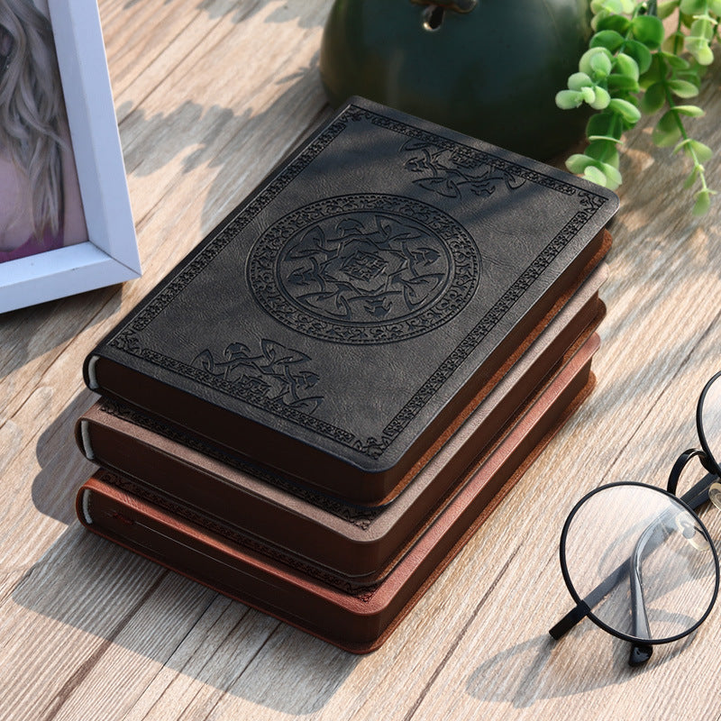 A6 leather mini notebook with embossed emblem on brown cover