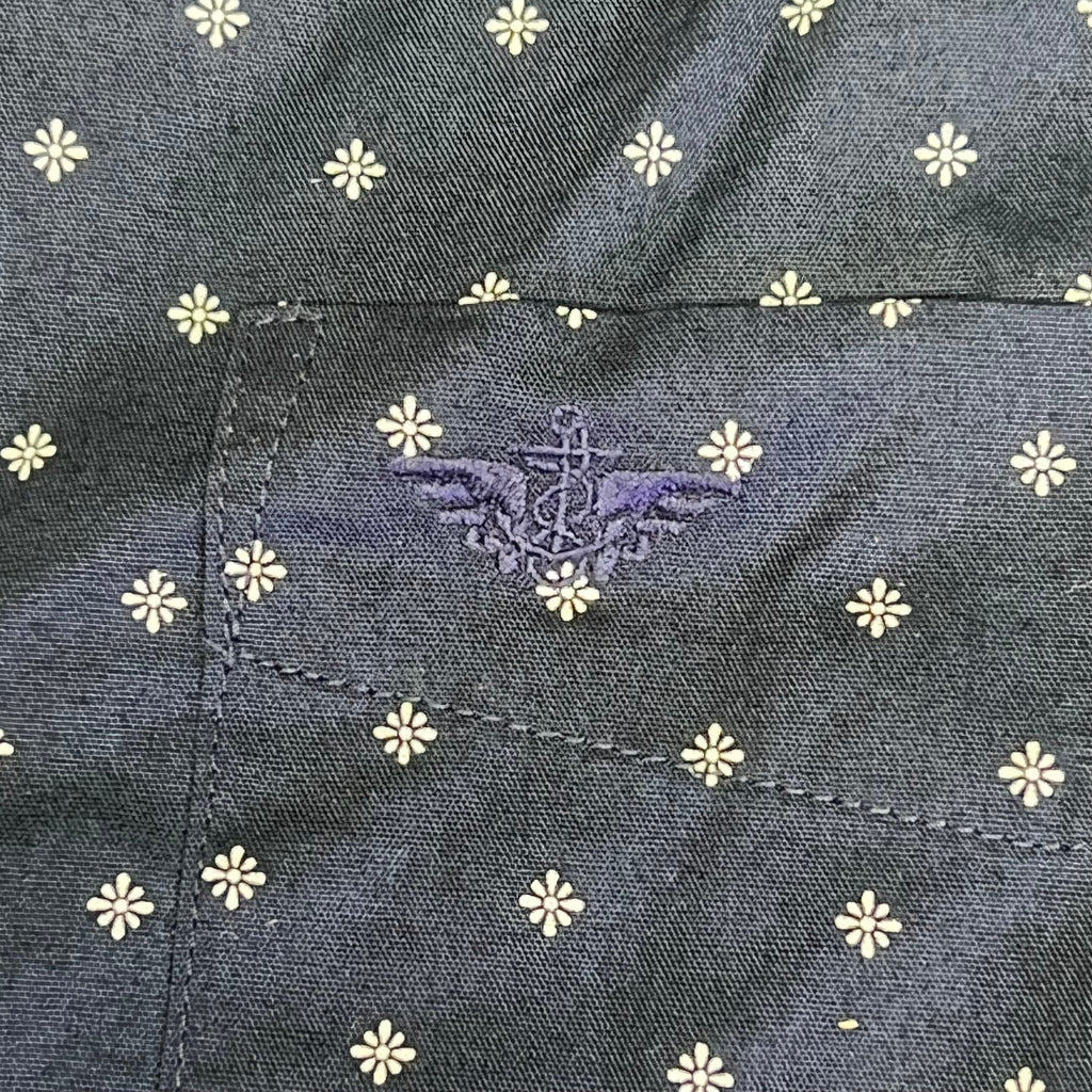 Navy shirt close-up with small white daisy pattern and stitched inner seam