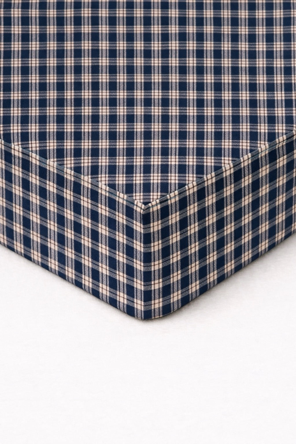 Blue plaid fitted crib sheet with elastic corner seams