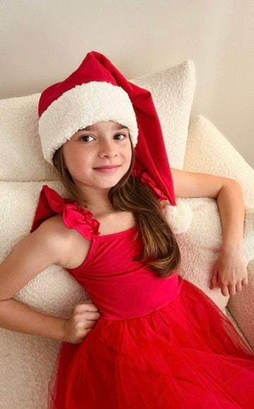 Red sleeveless tulle holiday dress with bow strap detail and Santa hat