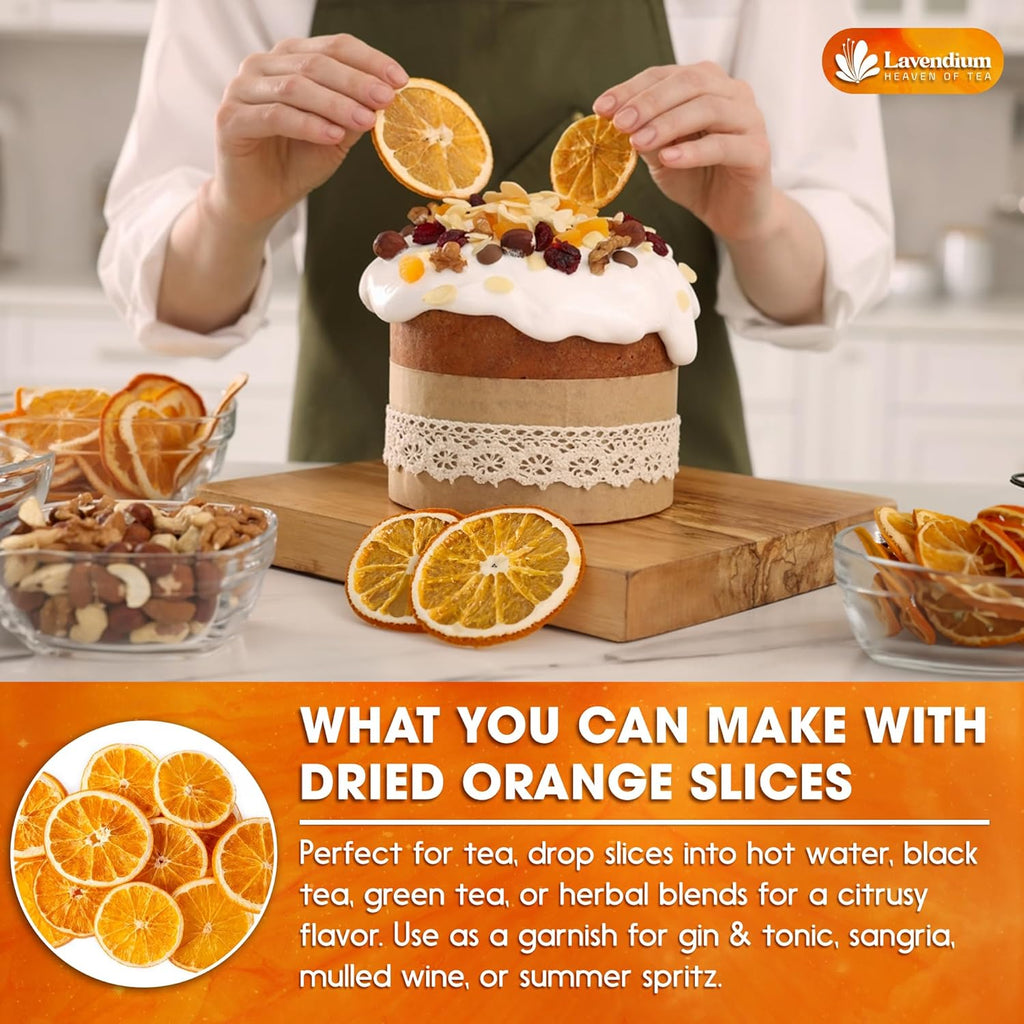 Cook holding dried orange slices over a table with baking items