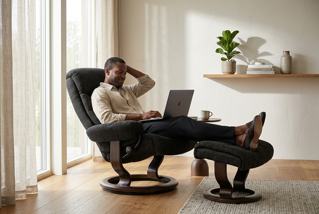 Dark recliner chair and ottoman with extended footrest, round swivel base