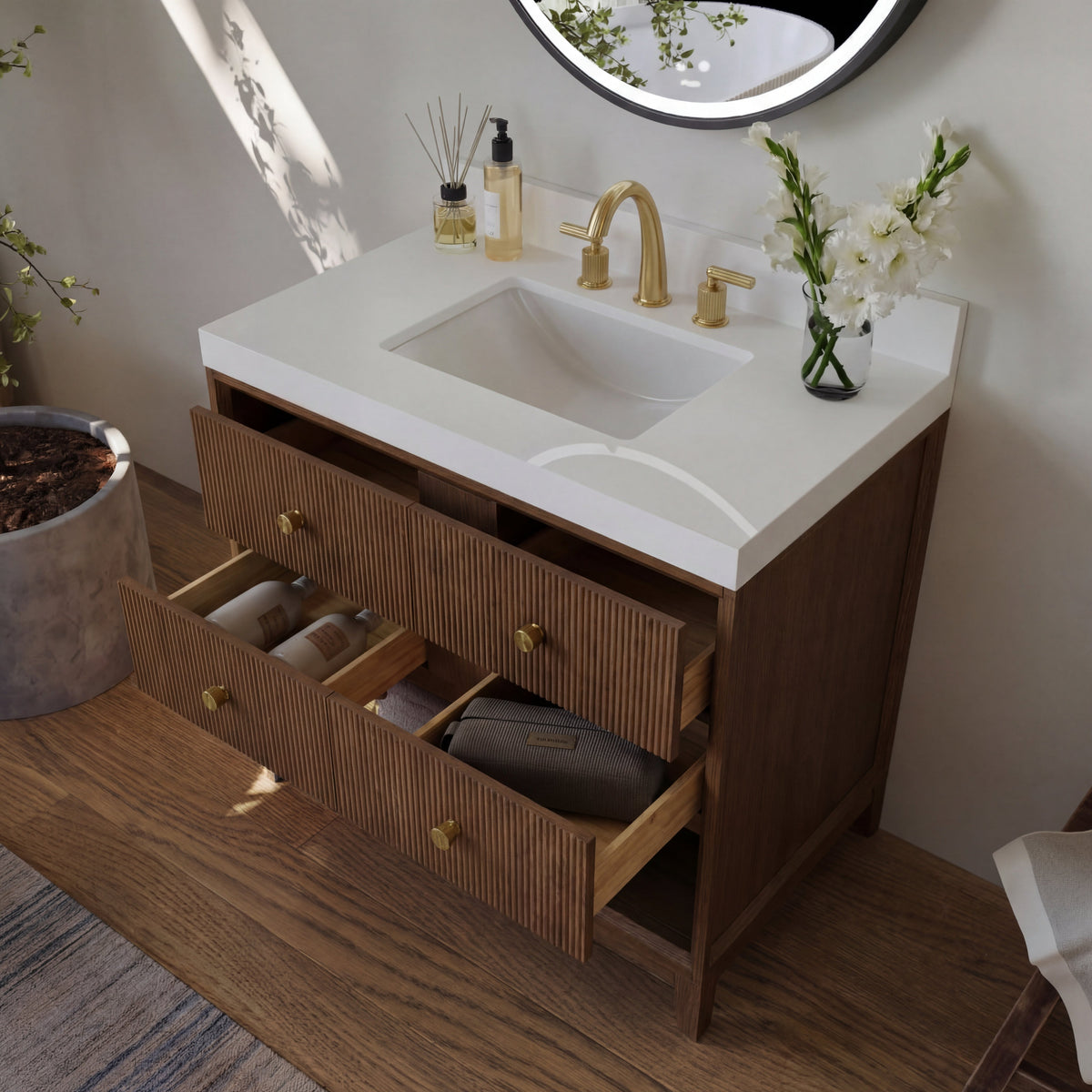 Chestnut bath vanity with open drawers, white sink top, gold faucet and countertop accessories