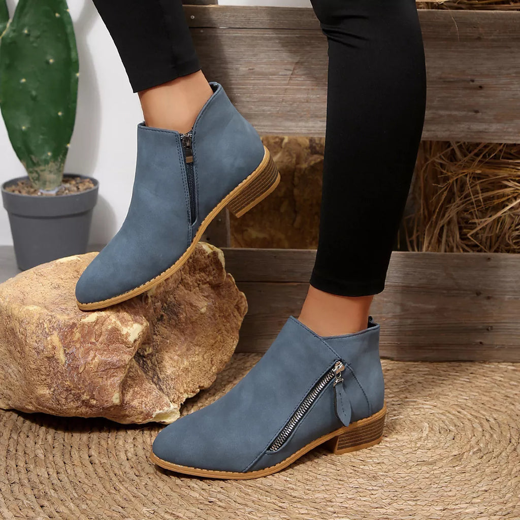 Dusty blue block-heel ankle boots with side zipper and tan rubber sole