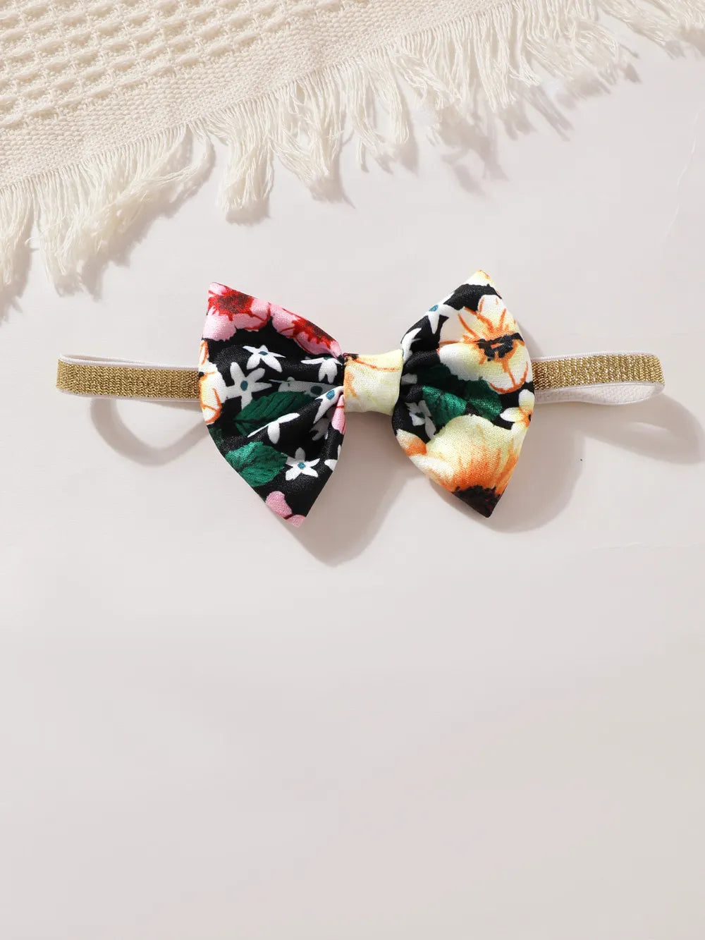 Bow headband with black floral fabric and peach center