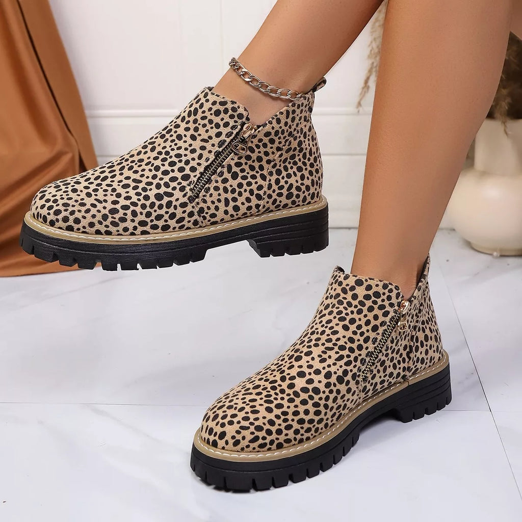 Leopard print ankle boots with side zipper and chain ankle strap, angled view