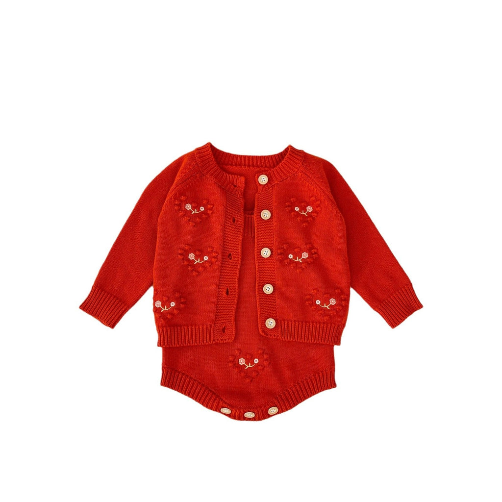 Red knit baby girl romper with cardigan-style button front and embroidered heart motifs