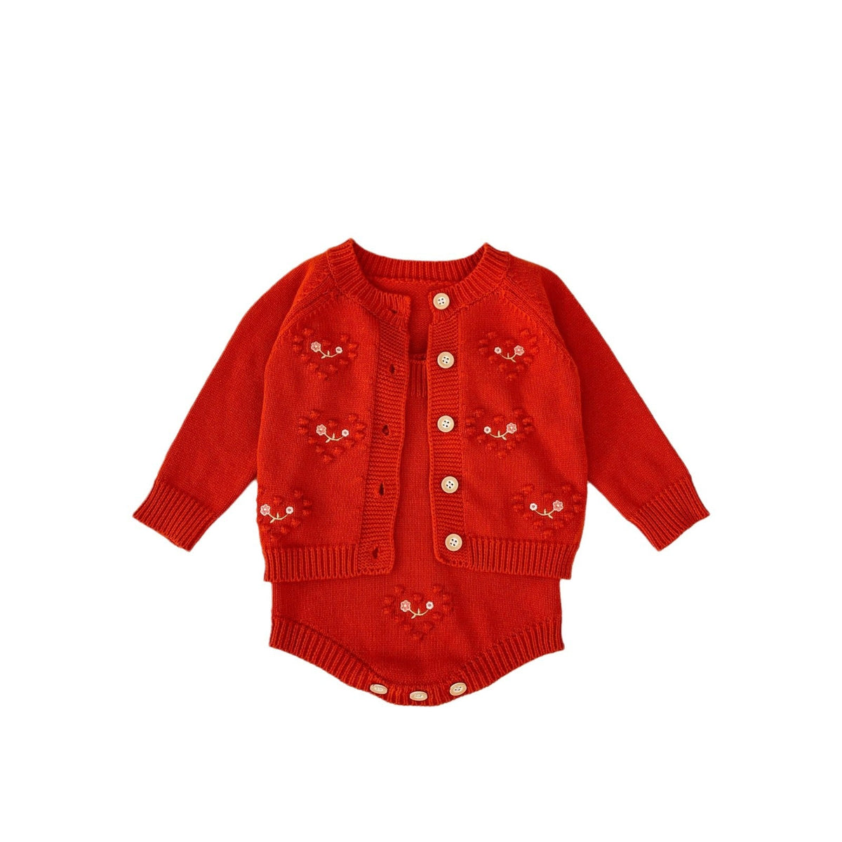 Red knit baby girl romper with cardigan-style button front and embroidered heart motifs