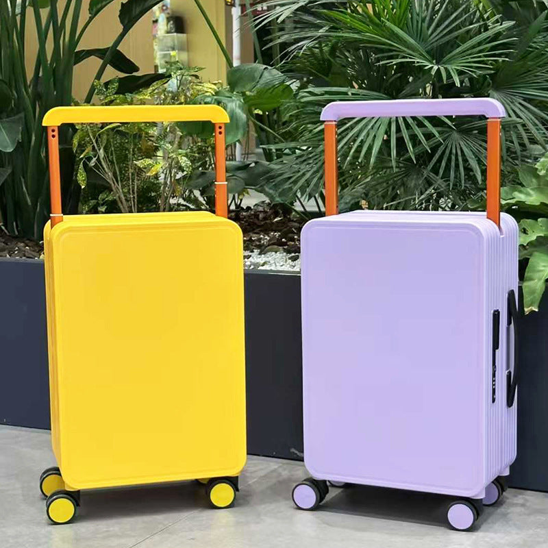 Two hard-shell wheeled suitcases with telescoping handles—yellow and lavender