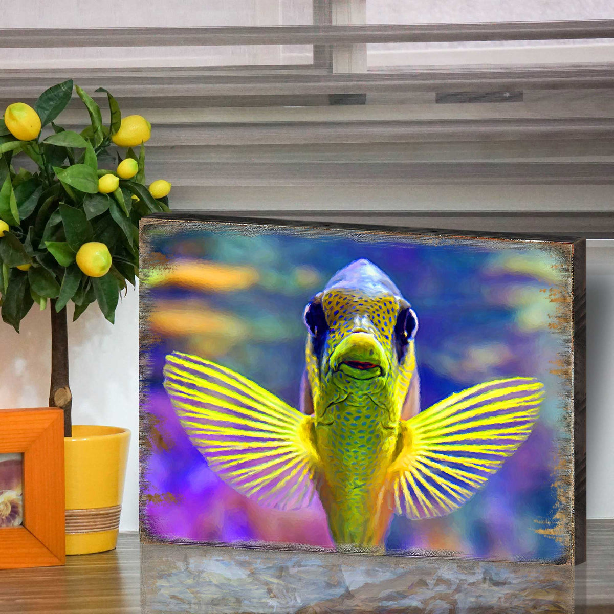 Tropical fish wall art in a dark wood frame, colorful winged fish illustration.