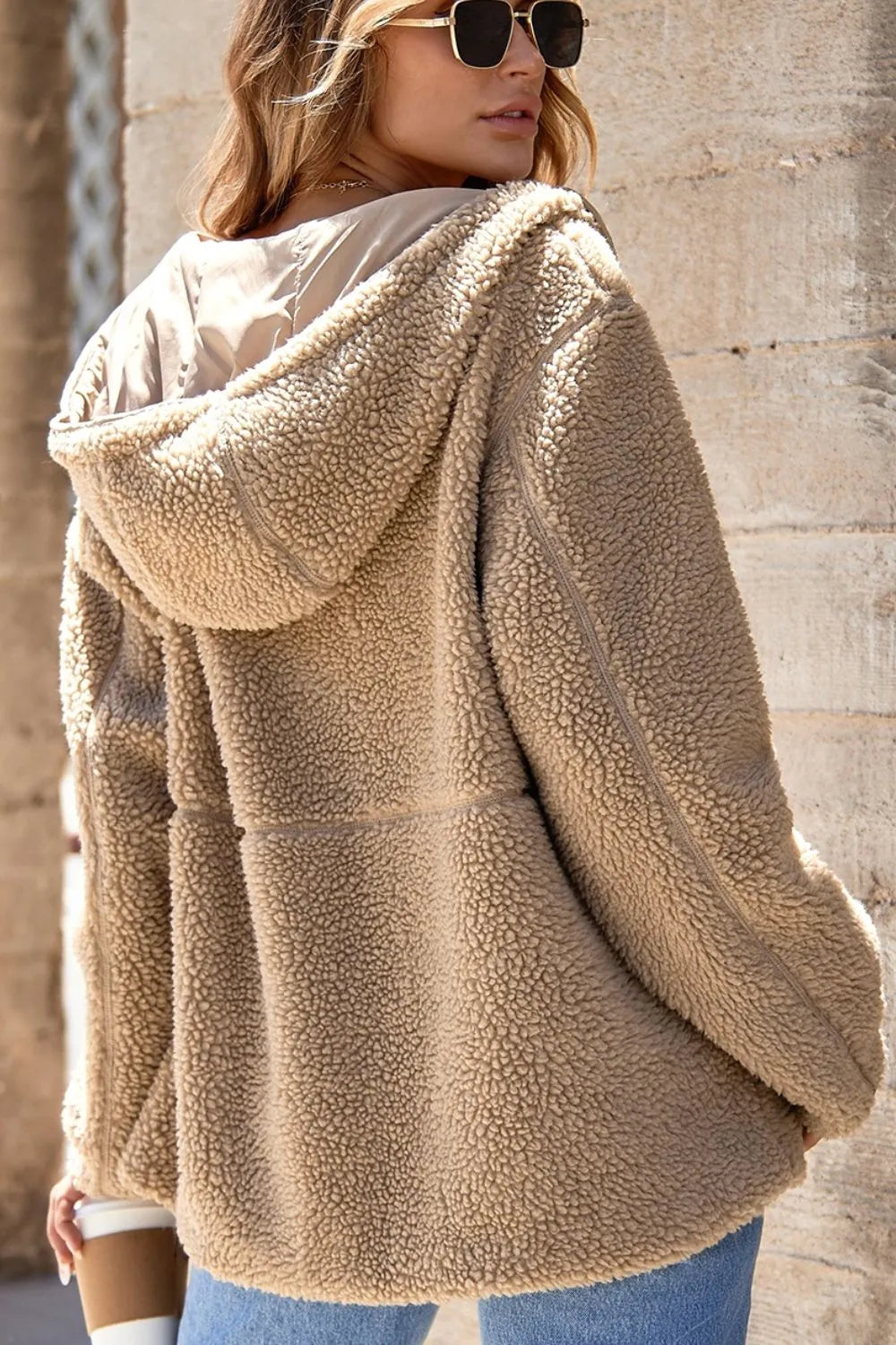 Khaki sherpa fleece zip-up hooded jacket viewed from the back with hood up