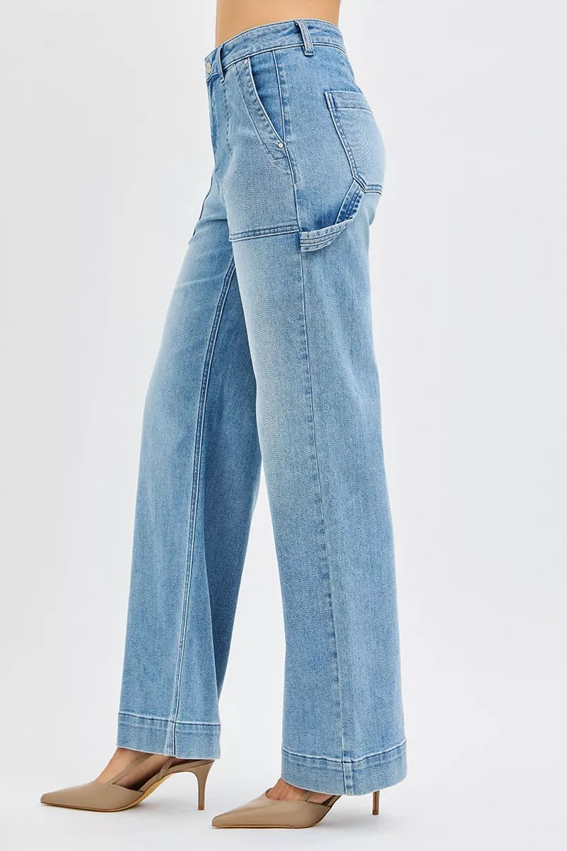 Medium wash high-rise straight-leg jeans from the side, belt loops and pocket