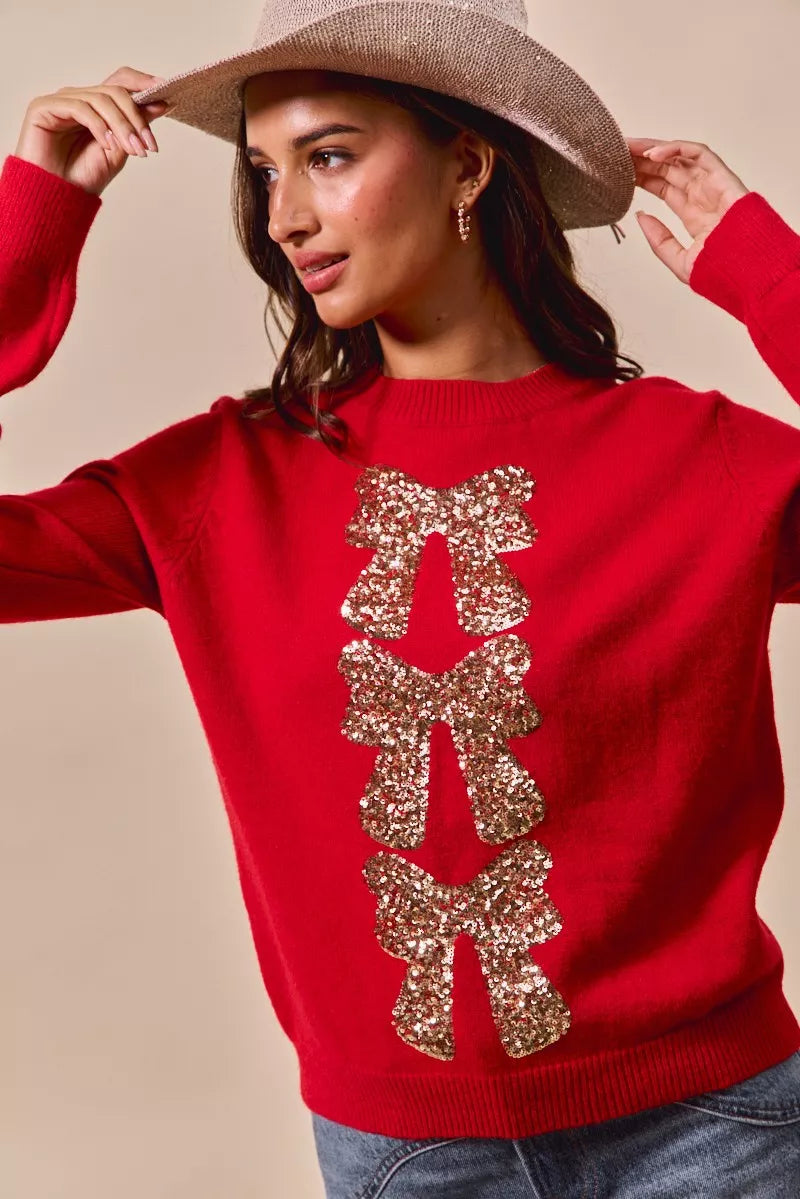 Red sweater with gold sequin bow centerpiece detail and ribbed crew neckline