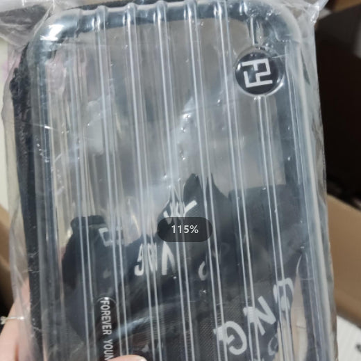 Cosmetic bag in clear plastic wrap with dark patterned exterior and side print.
