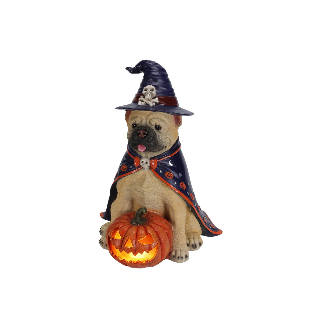Bulldog witch figurine with glowing orange jack-o-lantern on white background