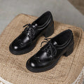 Black lace-up leather-style shoes with round toe, chunky heel, and stitched detailing.