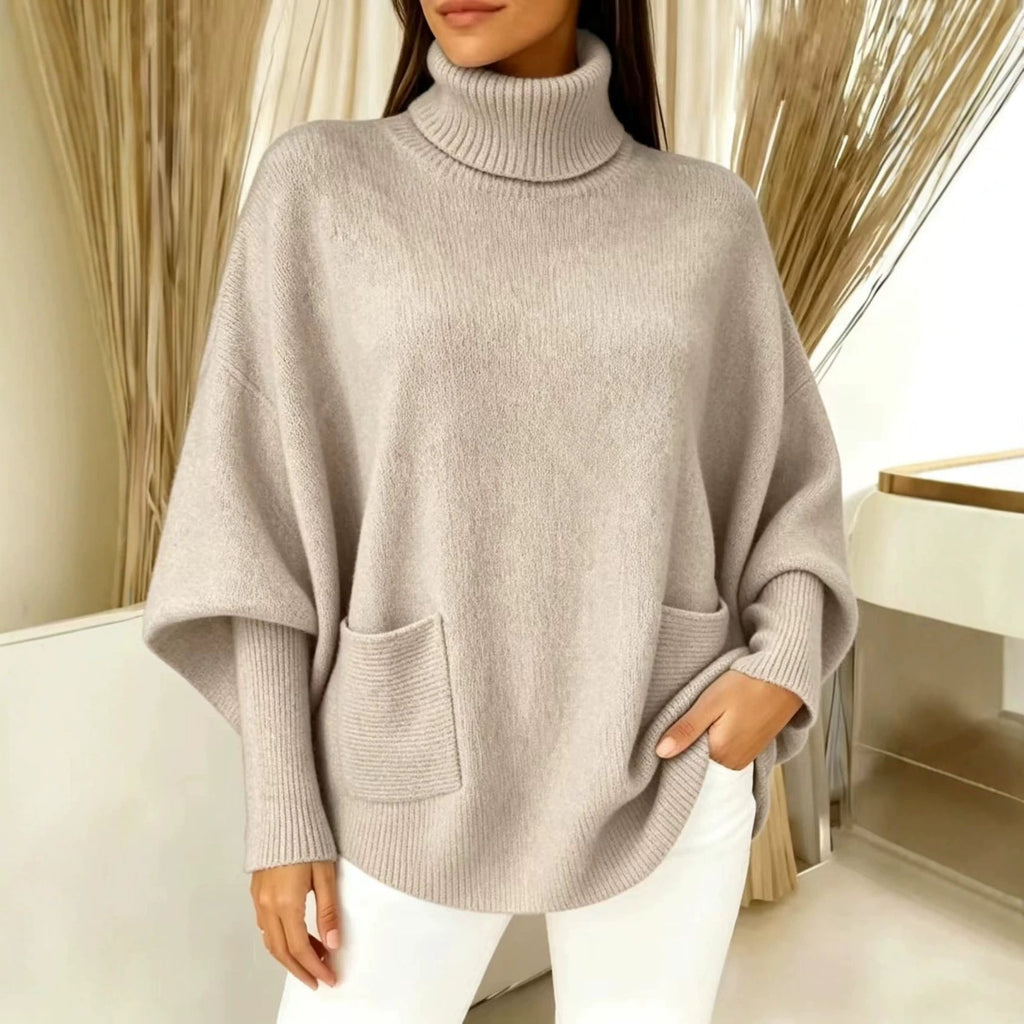 Taupe women’s turtleneck sweater with long sleeves and front patch pocket